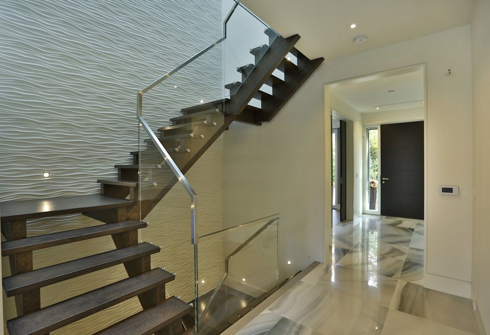 Mid-sized contemporary wood curved staircase in Toronto with open risers.