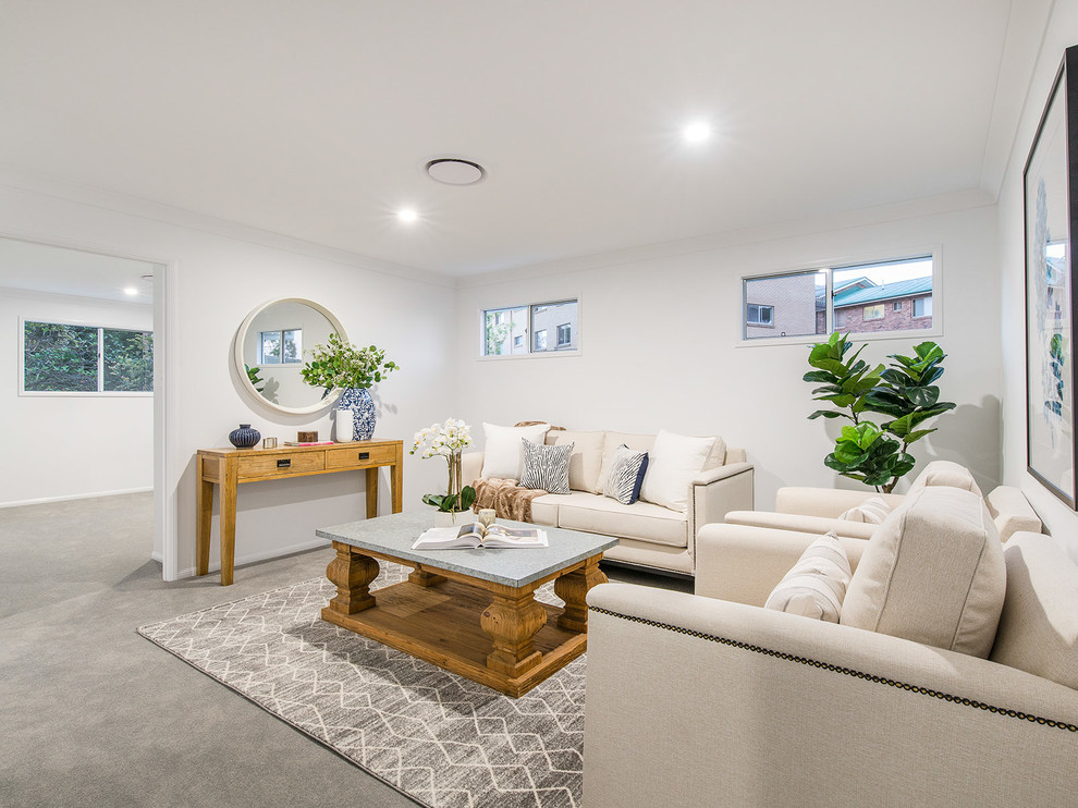 Photo of a mid-sized beach style formal enclosed living room in Brisbane with white walls, carpet and grey floor.