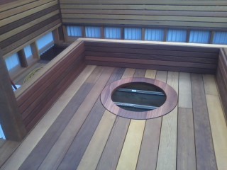 Inspiration for a mid-sized transitional backyard deck remodel in Vancouver with a fire pit and a pergola
