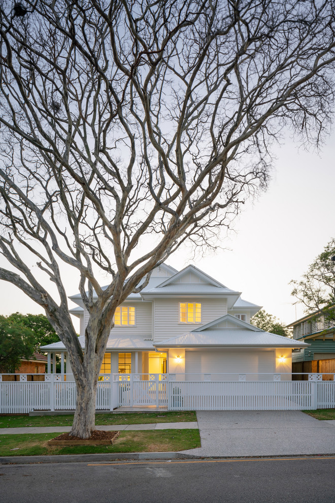 Design ideas for a traditional white house exterior in Brisbane with a metal roof.