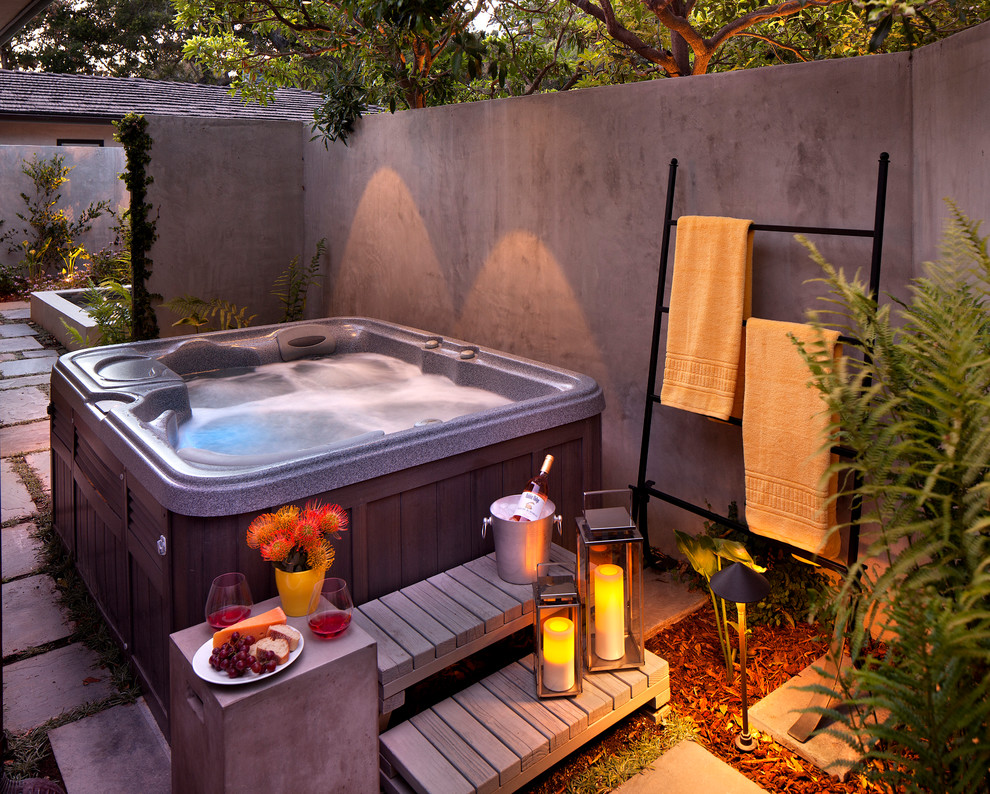 Mid-sized traditional side yard pool in Santa Barbara with natural stone pavers and a hot tub.