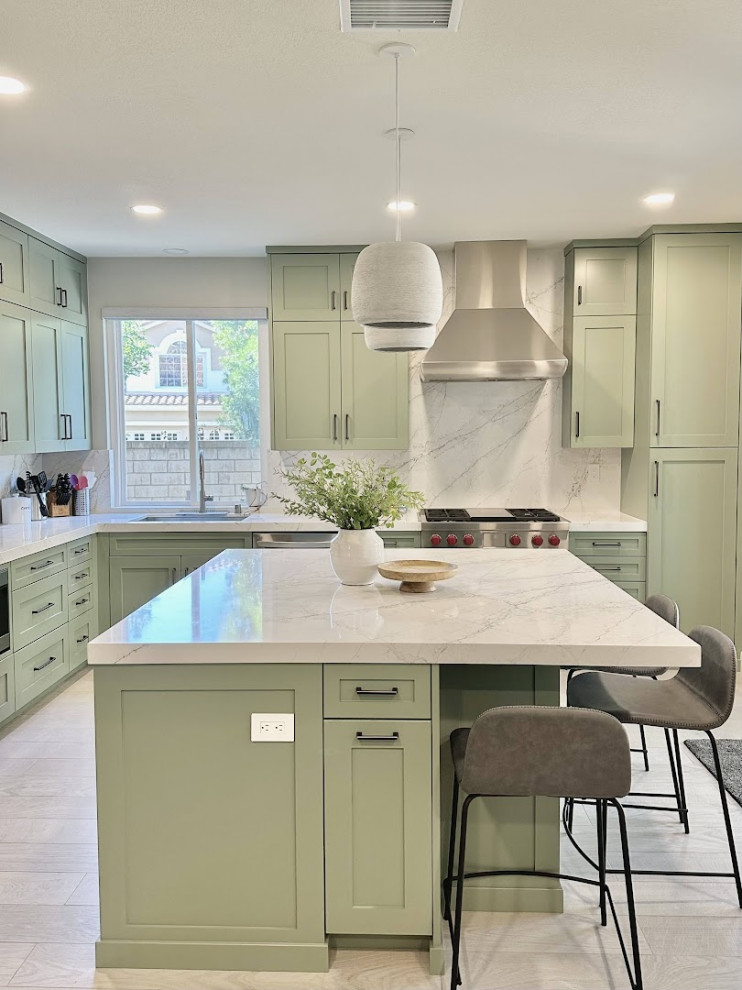 Photo of a mid-sized transitional galley kitchen pantry in Orange County with an undermount sink, shaker cabinets, green cabinets, laminate benchtops, white splashback, stainless steel appliances, ceramic floors, with island, multi-coloured floor, white benchtop and vaulted.