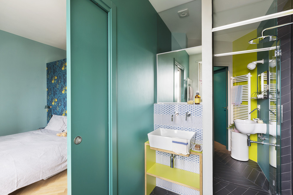 This is an example of a contemporary bathroom in Turin with a curbless shower, blue tile, gray tile, white tile, green walls, a vessel sink, wood benchtops, grey floor, a hinged shower door and green benchtops.