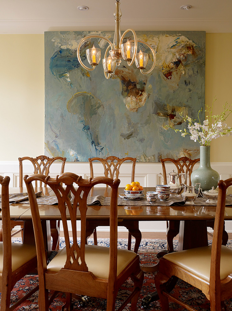 Photo of a large traditional dining room in San Francisco with yellow walls, medium hardwood floors and no fireplace.