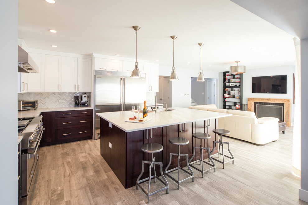 Mid-sized transitional l-shaped beige floor and porcelain tile open concept kitchen photo in Chicago with a single-bowl sink, shaker cabinets, dark wood cabinets, marble countertops, gray backsplash, marble backsplash, stainless steel appliances and an island