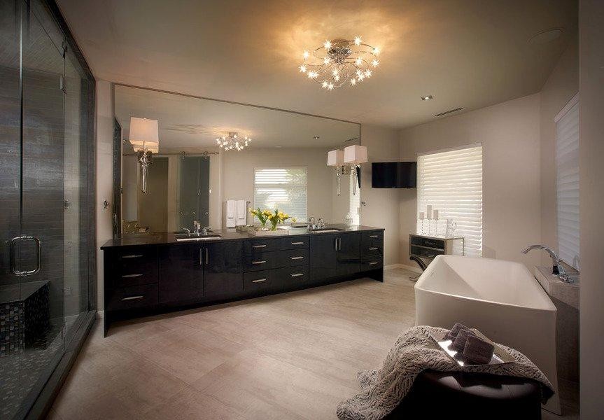 Inspiration for a large contemporary master bathroom in Las Vegas with dark wood cabinets, a freestanding tub, an alcove shower, gray tile, beige walls, porcelain floors, an undermount sink, engineered quartz benchtops, beige floor and a hinged shower door.