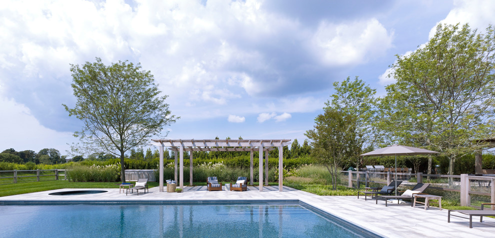 Country rectangular pool in New York with a hot tub.