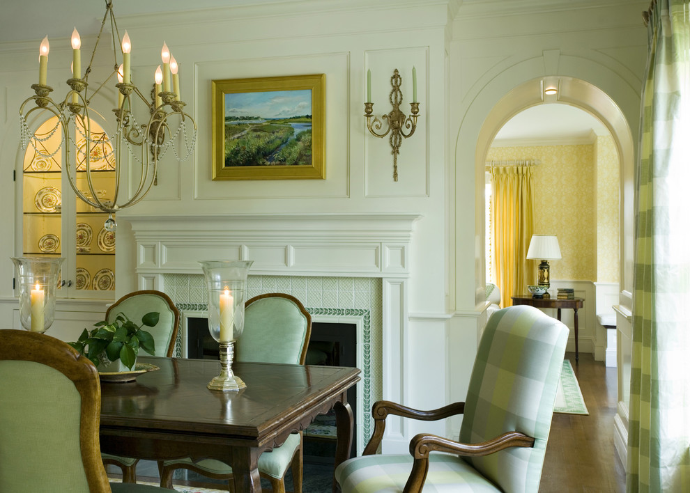 Photo of a traditional separate dining room in Boston with a standard fireplace and a tile fireplace surround.