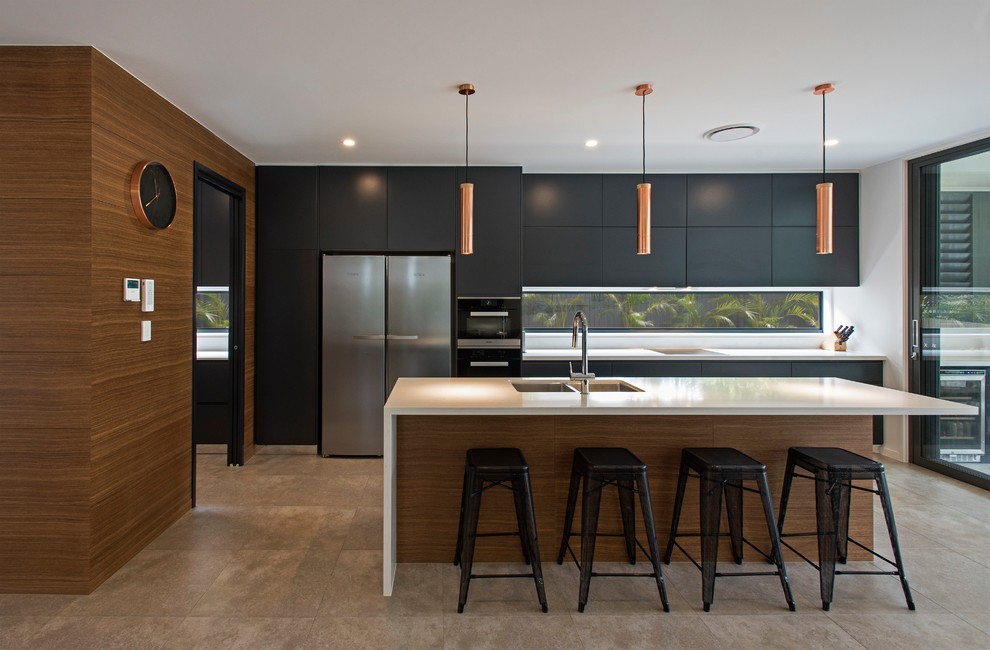 Photo of a contemporary galley kitchen in Brisbane with black cabinets, window splashback, ceramic floors, with island, grey floor, white benchtop, a double-bowl sink, flat-panel cabinets and stainless steel appliances.