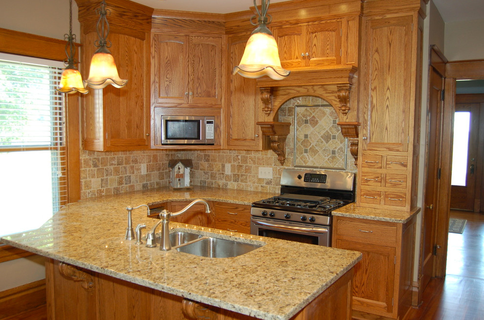 Example of a small transitional u-shaped light wood floor enclosed kitchen design with a double-bowl sink, beaded inset cabinets, light wood cabinets, granite countertops, beige backsplash, ceramic backsplash, stainless steel appliances and no island