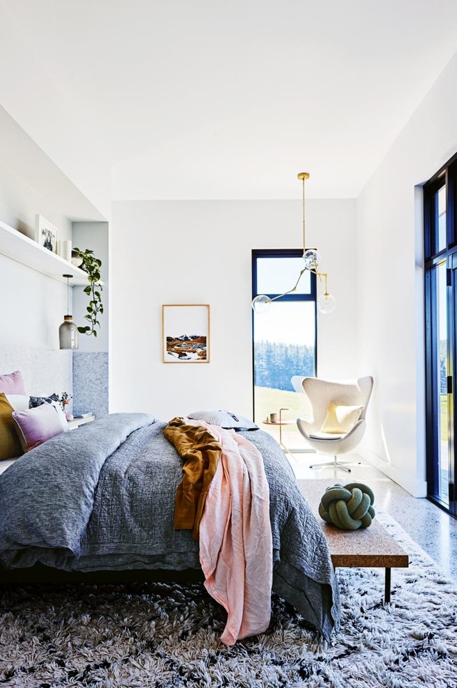 Inspiration for a large country master bedroom in Other with white walls, concrete floors, no fireplace and grey floor.