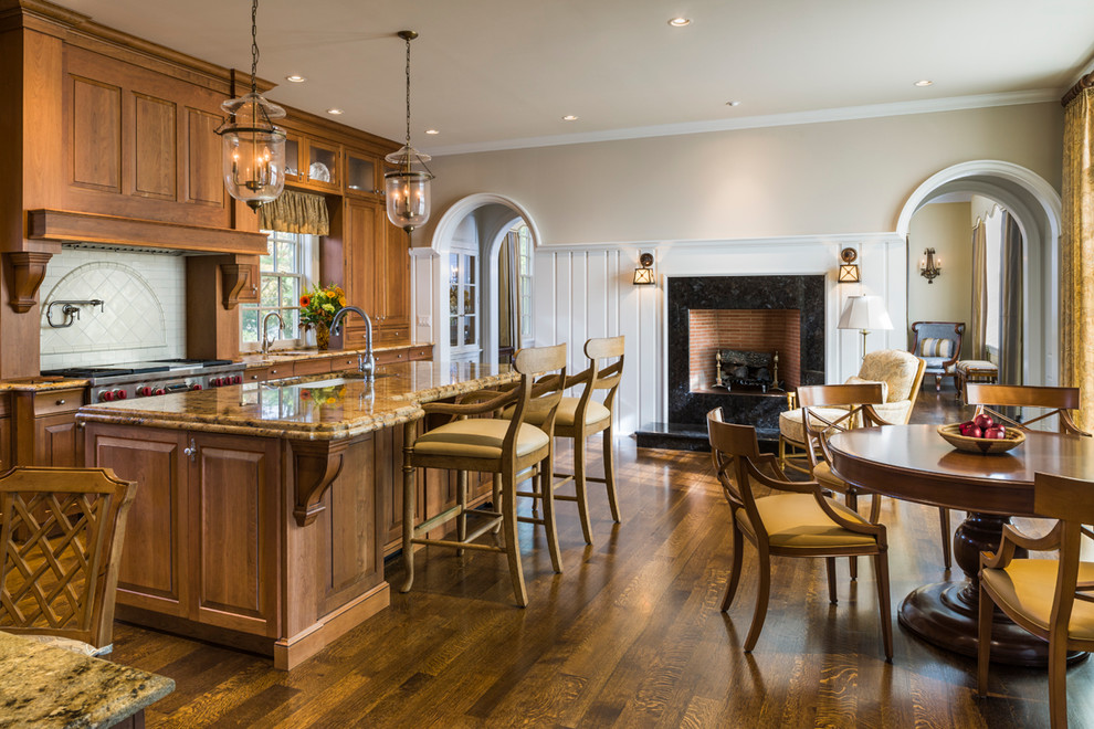 Traditional eat-in kitchen in Philadelphia with an undermount sink, raised-panel cabinets, medium wood cabinets, beige splashback and stainless steel appliances.