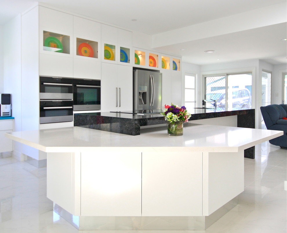 Design ideas for a large contemporary single-wall eat-in kitchen in Sydney with an undermount sink, flat-panel cabinets, white cabinets, granite benchtops, stainless steel appliances, ceramic floors and with island.