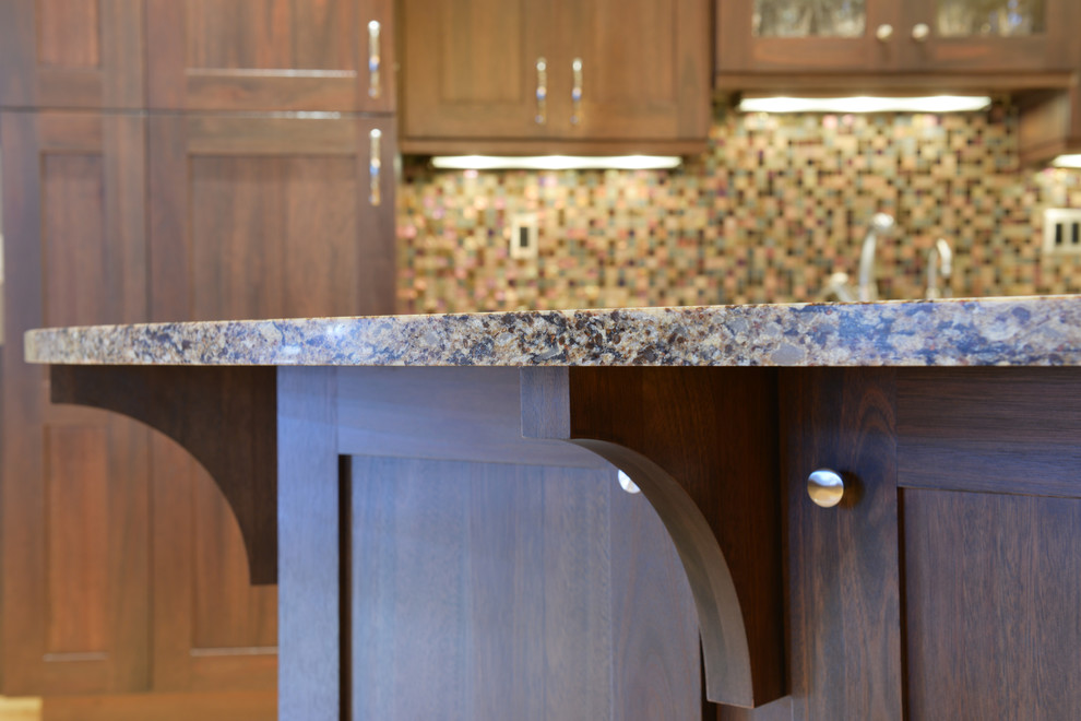 Inspiration for a mid-sized transitional l-shaped light wood floor open concept kitchen remodel with an undermount sink, shaker cabinets, dark wood cabinets, quartzite countertops, multicolored backsplash, mosaic tile backsplash, stainless steel appliances and an island