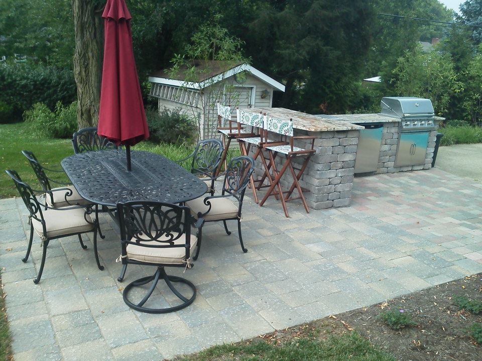 Mid-sized traditional backyard patio in Other with an outdoor kitchen, concrete pavers and no cover.