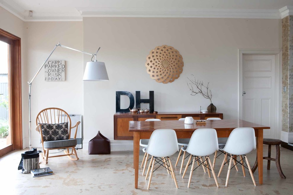 Inspiration for a mid-sized midcentury dining room in Adelaide with beige walls.