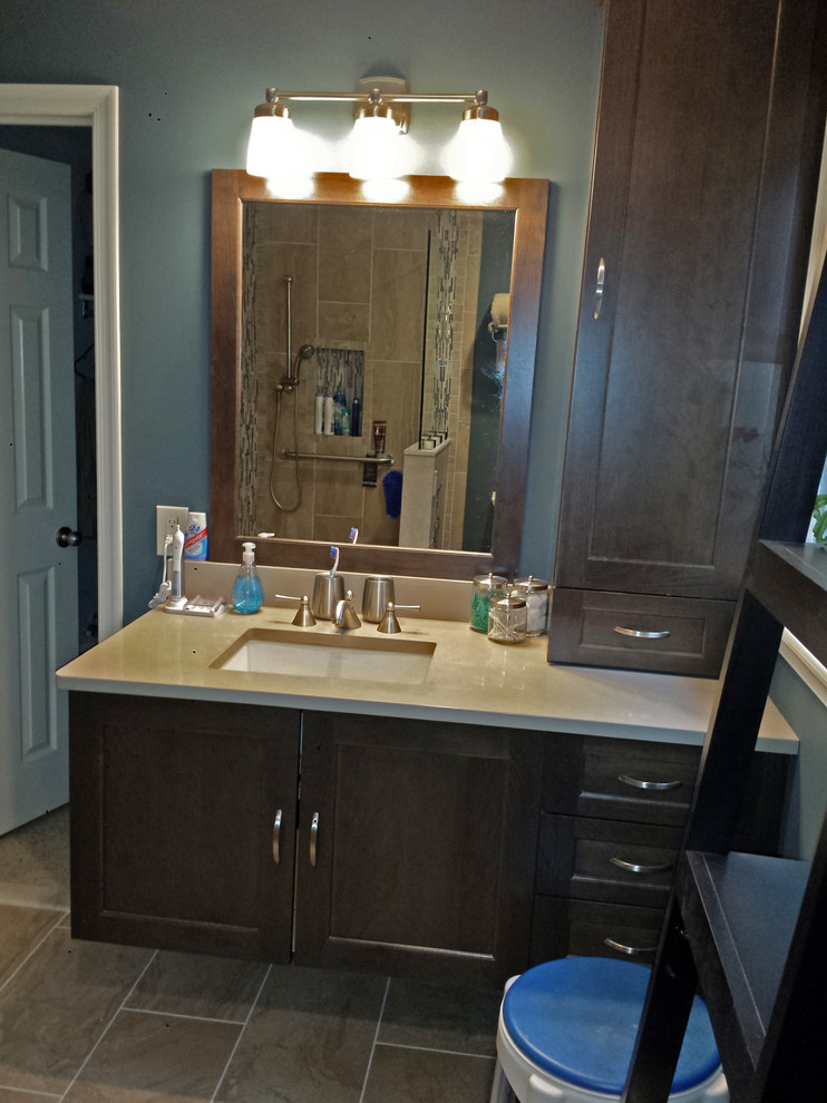 Photo of a mid-sized transitional master bathroom in Philadelphia with flat-panel cabinets, dark wood cabinets, a curbless shower, a two-piece toilet, gray tile, porcelain tile, blue walls, porcelain floors, engineered quartz benchtops and an undermount sink.