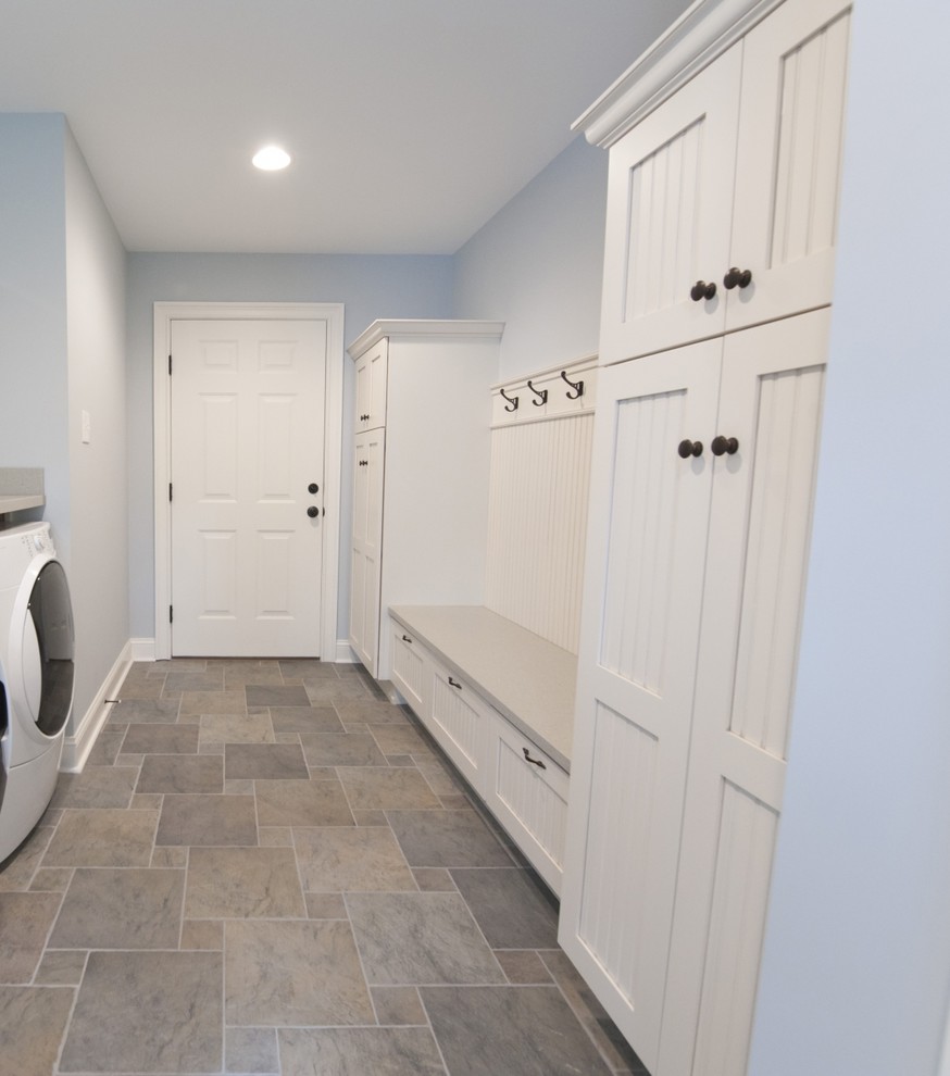 Mid-sized country mudroom in Other with blue walls, vinyl floors, a single front door, a white front door and multi-coloured floor.