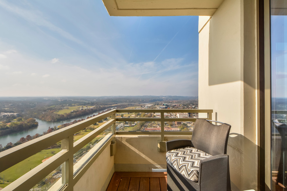 Example of a small transitional balcony design in Austin with decking and no cover
