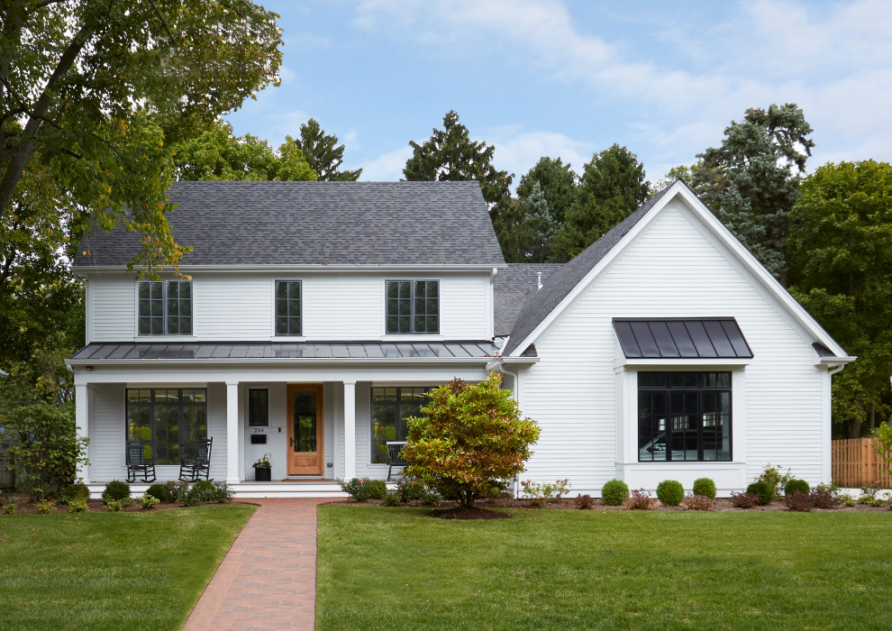 Immagine della villa bianca country a due piani di medie dimensioni con rivestimento con lastre in cemento, tetto a capanna, copertura mista, tetto grigio e pannelli sovrapposti