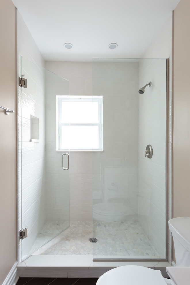 Стильный дизайн: главная ванная комната среднего размера в современном стиле с душевой комнатой, унитазом-моноблоком, белой плиткой, разноцветными стенами, деревянным полом, врезной раковиной, столешницей из искусственного кварца, коричневым полом и душем с раздвижными дверями - последний тренд