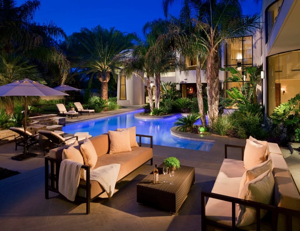 Large contemporary backyard custom-shaped lap pool in Las Vegas with stamped concrete.