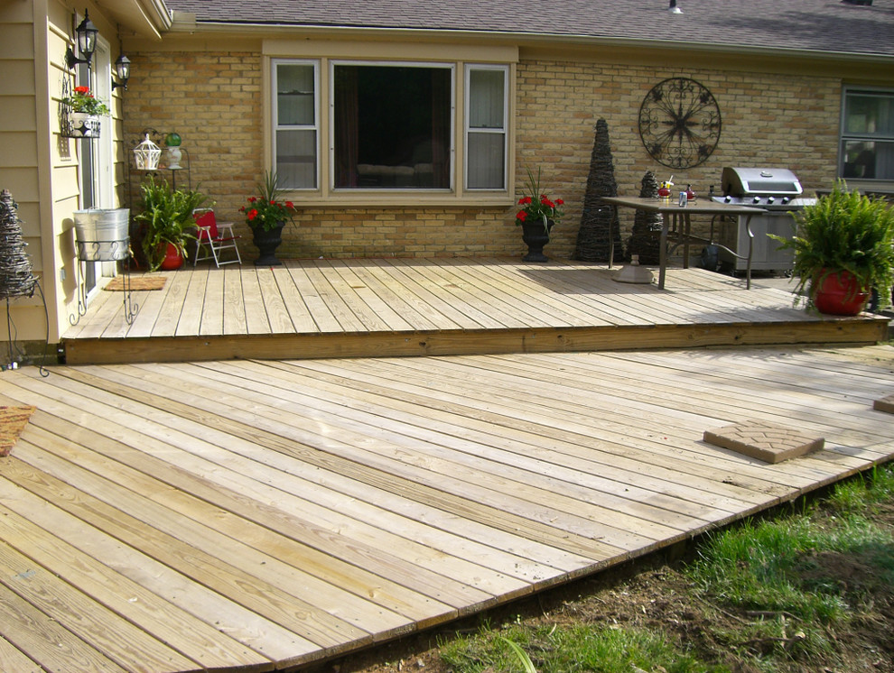 Inspiration for a large timeless backyard outdoor kitchen deck remodel with no cover