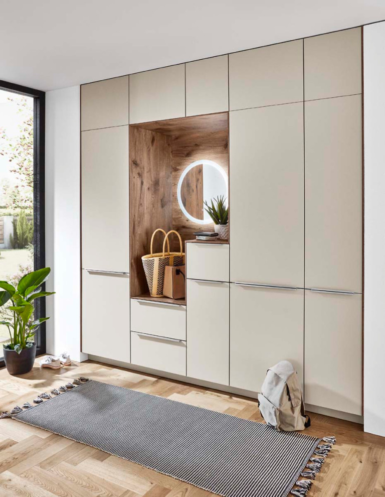Photo of a mid-sized scandinavian l-shaped eat-in kitchen in Other with a single-bowl sink, recessed-panel cabinets, distressed cabinets, quartzite benchtops, beige splashback, glass sheet splashback, panelled appliances, laminate floors, with island, brown floor and beige benchtop.