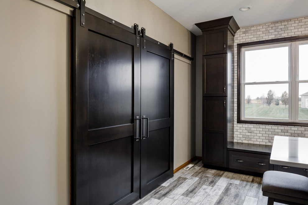 Inspiration for a mid-sized transitional l-shaped ceramic tile and multicolored floor eat-in kitchen remodel with an undermount sink, shaker cabinets, medium tone wood cabinets, quartz countertops, white backsplash, marble backsplash, stainless steel appliances, an island and white countertops