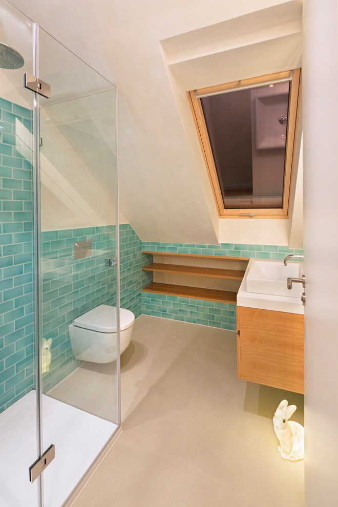Photo of a small scandinavian 3/4 bathroom in Berlin with flat-panel cabinets, medium wood cabinets, a curbless shower, a wall-mount toilet, subway tile, white walls, a vessel sink, wood benchtops, white floor, a hinged shower door and white benchtops.