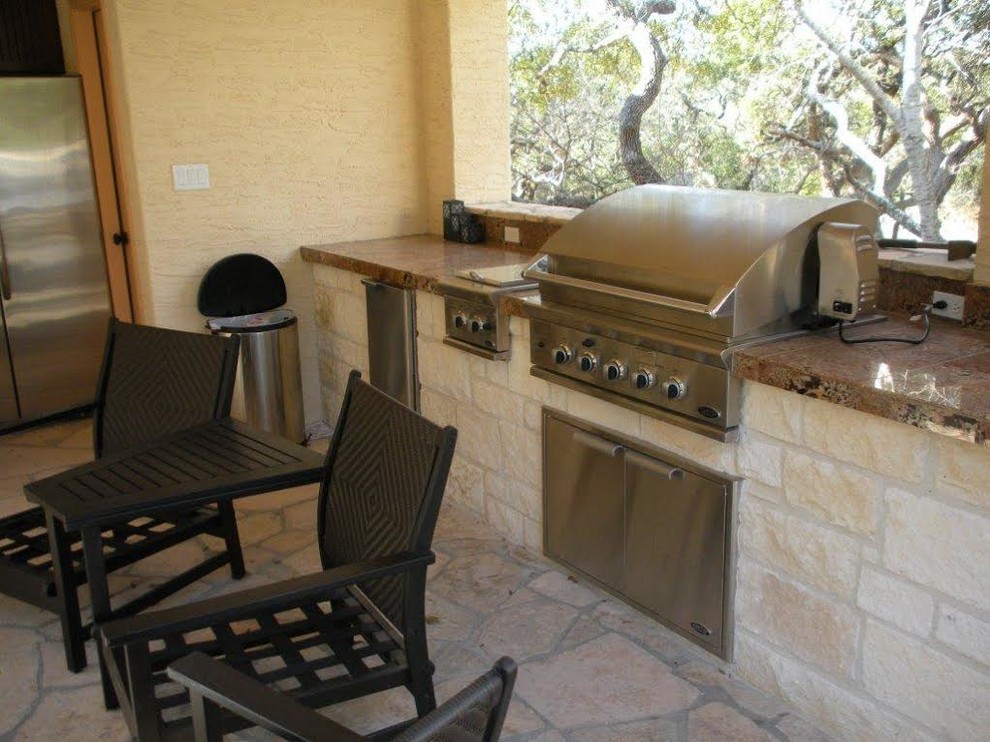 Photo of a mid-sized backyard patio in Austin with natural stone pavers and a gazebo/cabana.
