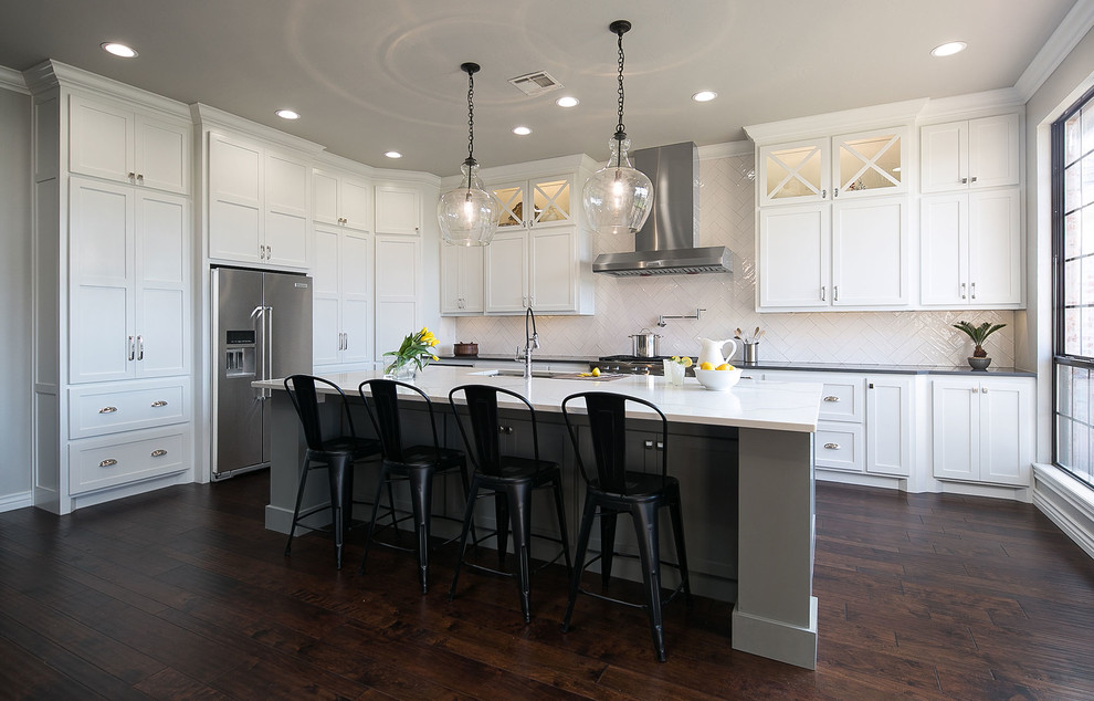 Transitional l-shaped kitchen in Oklahoma City with an undermount sink, shaker cabinets, white cabinets, white splashback, dark hardwood floors and with island.