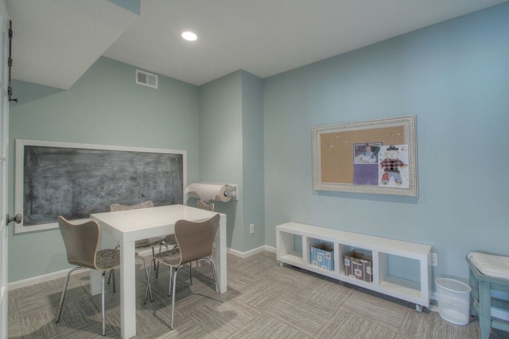 This is an example of a mid-sized traditional gender-neutral kids' playroom for kids 4-10 years old in Kansas City with blue walls, porcelain floors and beige floor.