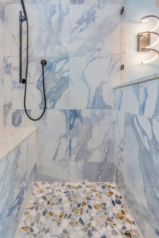 Design ideas for an expansive modern bathroom in Tampa with a corner bath, a shower/bath combination, a one-piece toilet, blue walls, concrete flooring, a built-in sink, multi-coloured floors, a sliding door, double sinks and a drop ceiling.