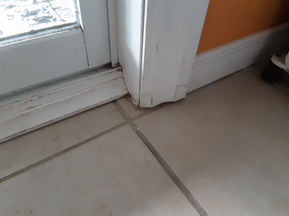 Best way to seal hole beneath baseboard that leads outside?
