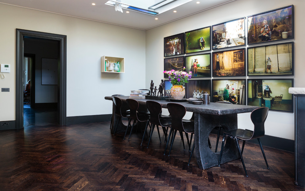 Design ideas for a contemporary separate dining room in London with beige walls, dark hardwood floors and brown floor.