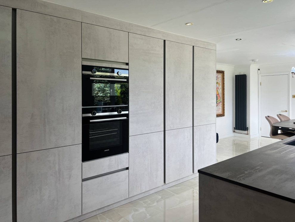 Small modern galley kitchen in London with flat-panel cabinets.