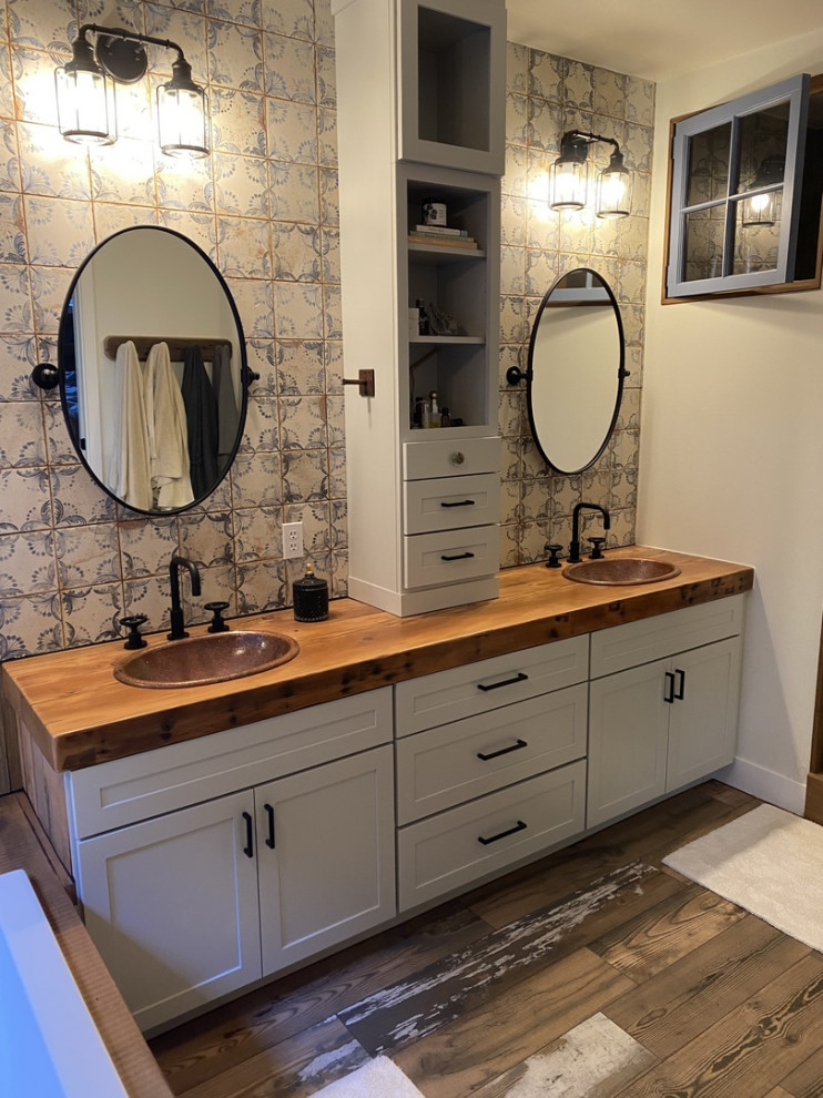 This is an example of a small country master bathroom in Atlanta with shaker cabinets, white cabinets, a drop-in tub, mosaic tile, medium hardwood floors, wood benchtops, white floor, brown benchtops, a double vanity and a built-in vanity.