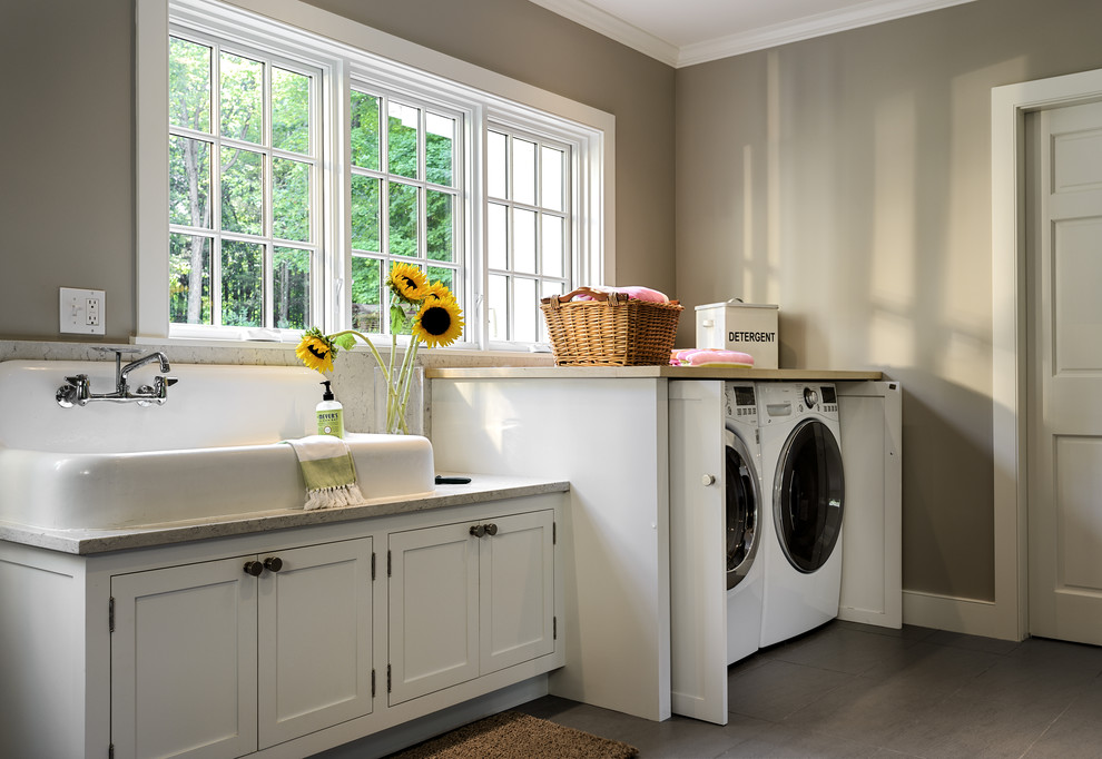 Photo of a mid-sized country laundry room in New York with white cabinets, marble benchtops, ceramic floors, shaker cabinets, a drop-in sink and grey walls.