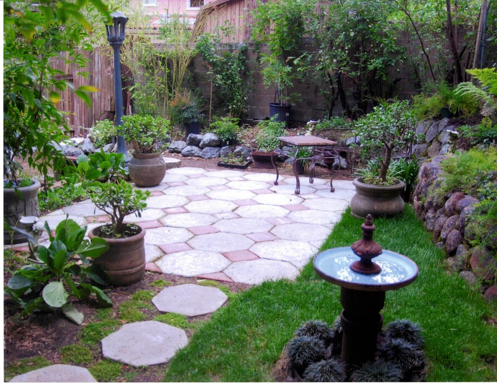 Inspiration for a large modern sloped shaded xeriscape in San Francisco with a water feature and concrete pavers.