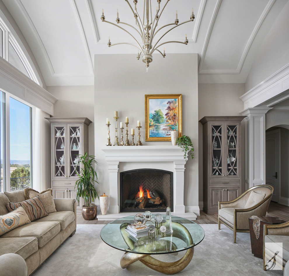 Inspiration for a traditional formal open plan living room in Denver with grey walls, medium hardwood flooring, a standard fireplace, a concrete fireplace surround, no tv and brown floors.