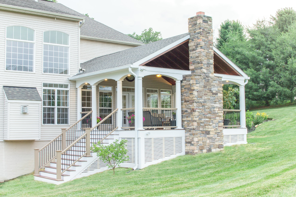 Deck - large transitional backyard deck idea in Baltimore with a fire pit and a roof extension
