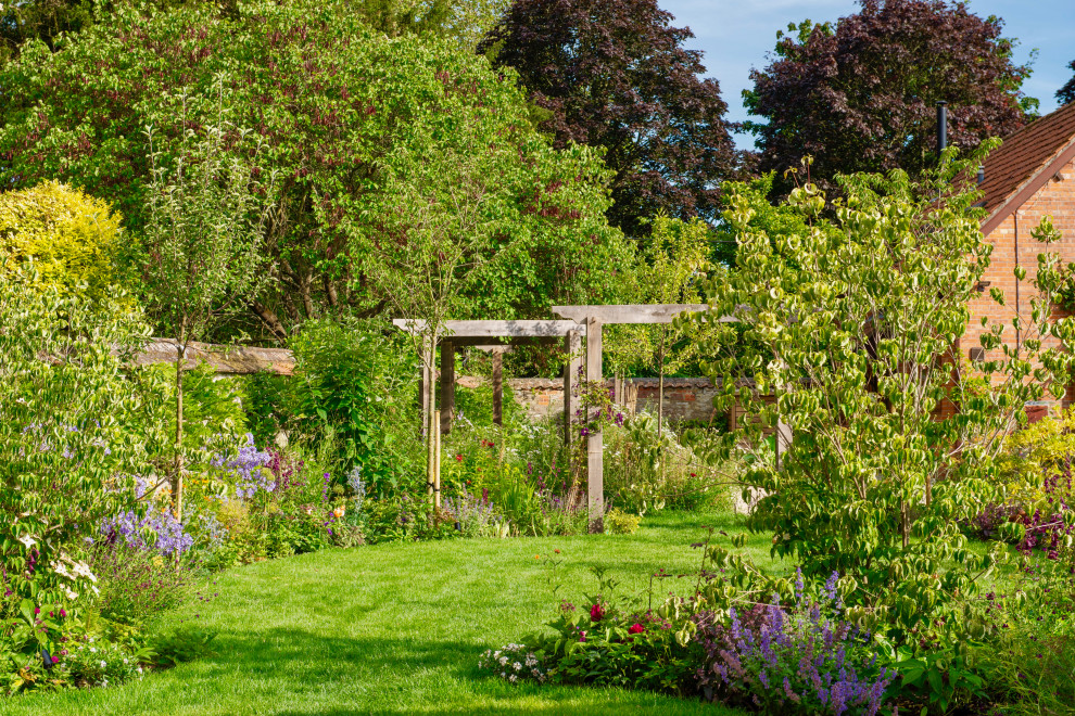 Photo of a mid-sized mediterranean backyard garden in Wiltshire.