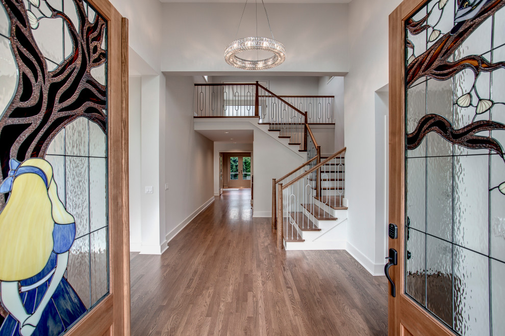 Traditional entrance in Seattle with white walls, medium hardwood flooring, a double front door, a brown front door and brown floors.