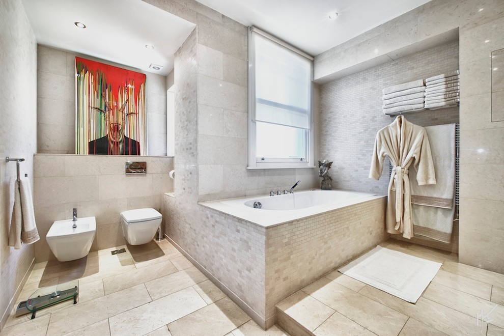 Contemporary bathroom in London with a bidet and beige tile.