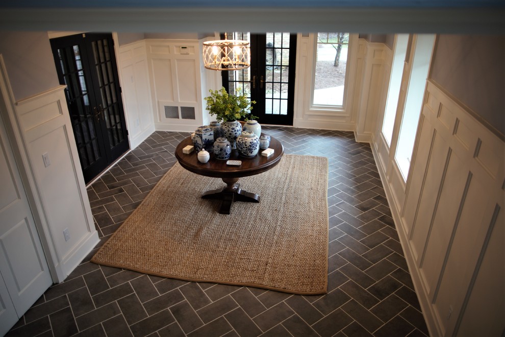 Inspiration for a mid-sized traditional foyer in DC Metro with blue walls, ceramic floors, a double front door, a black front door and grey floor.