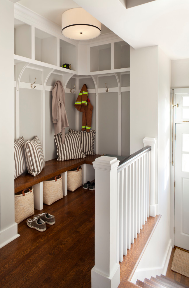 Inspiration for a transitional medium tone wood floor and wallpaper entryway remodel in Denver with gray walls
