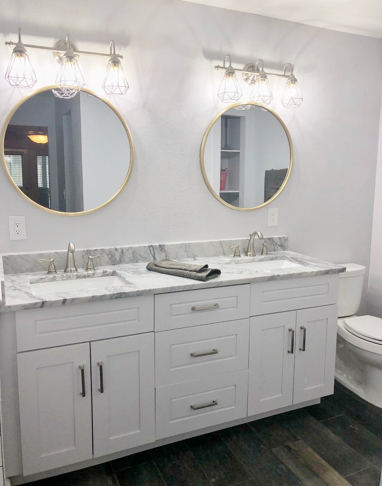 Mid-sized country master bathroom in Orlando with shaker cabinets, white cabinets, a double shower, a one-piece toilet, white tile, subway tile, grey walls, porcelain floors, an undermount sink, quartzite benchtops, brown floor, a hinged shower door and grey benchtops.
