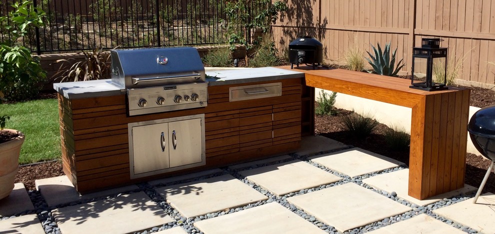 Photo of a mid-sized mediterranean backyard patio in San Diego with an outdoor kitchen and concrete pavers.