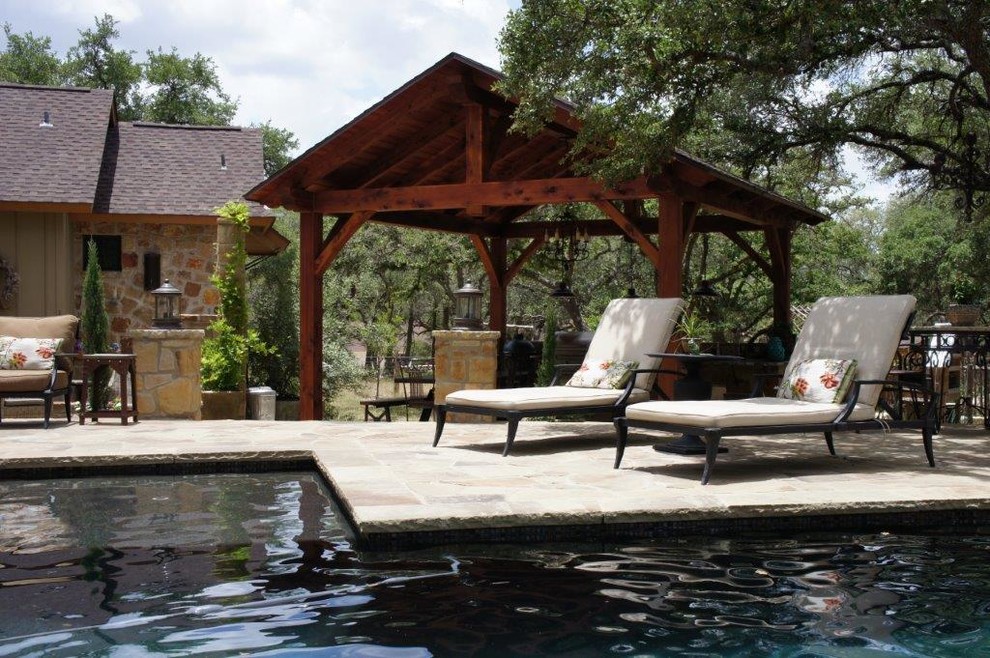 Example of a mid-sized mountain style backyard stone and rectangular lap pool fountain design in Austin